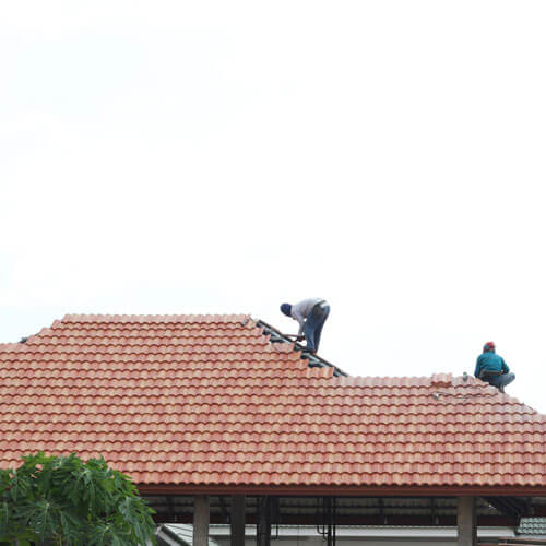 Worker Install Roof Tile For New House In Construction Site