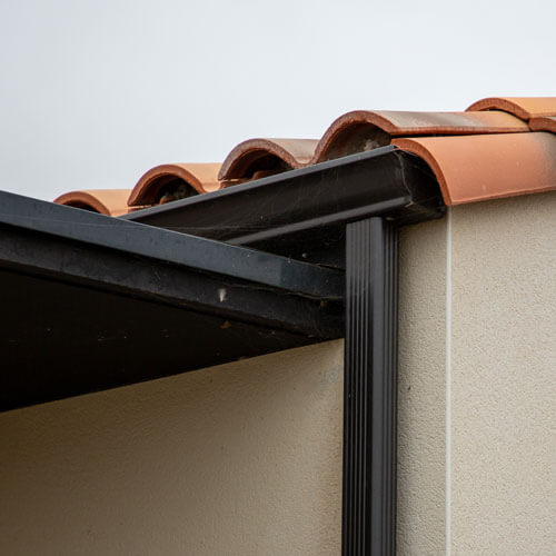 Modern Dark Black Roof Gutter And Drain Pipe With Copy Space