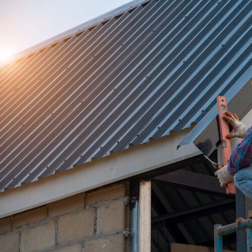 Roofer Working On Roof Structure,roofer Installing Metal Sheet O